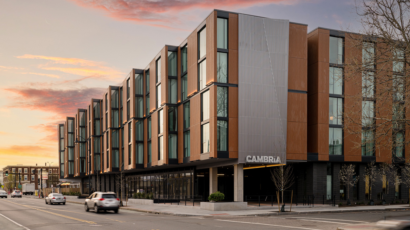 Exterior of Cambria hotel from the street at sunset